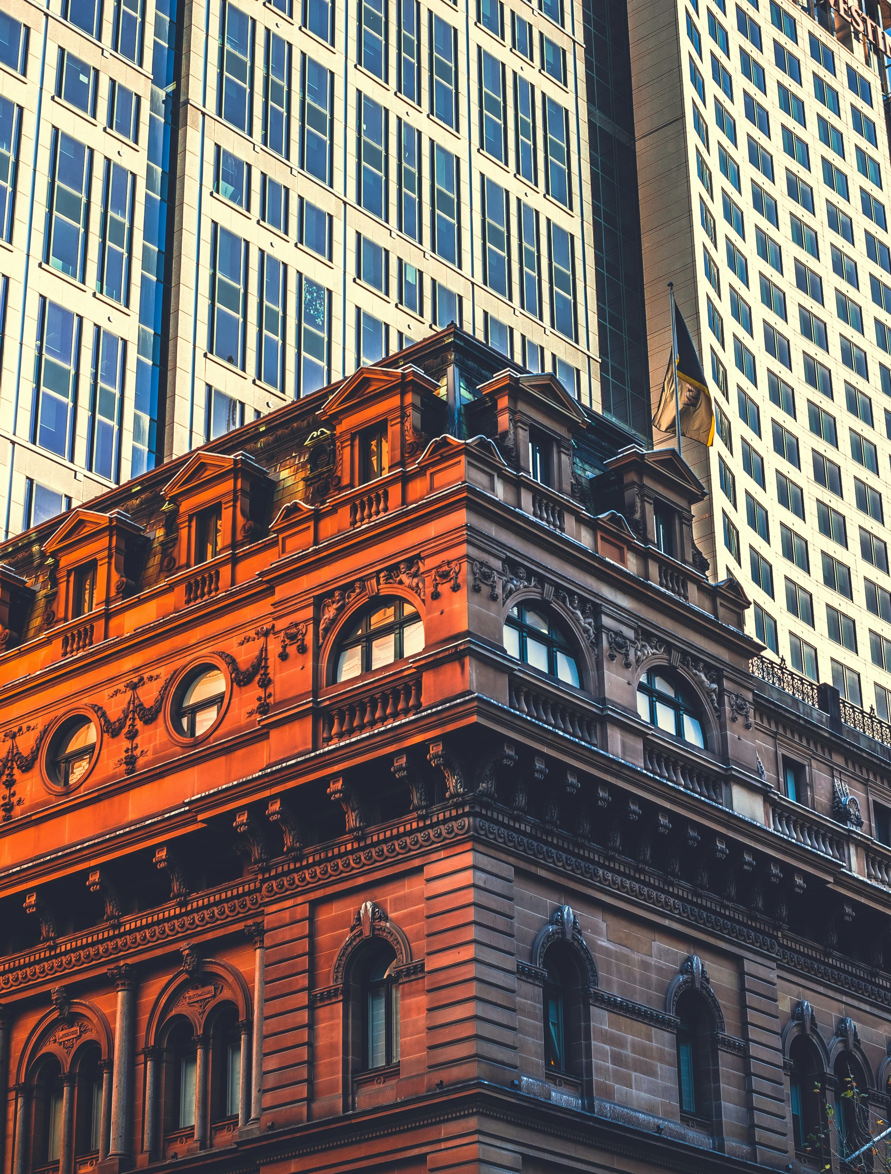 Heritage building facade beside a modern glass tower