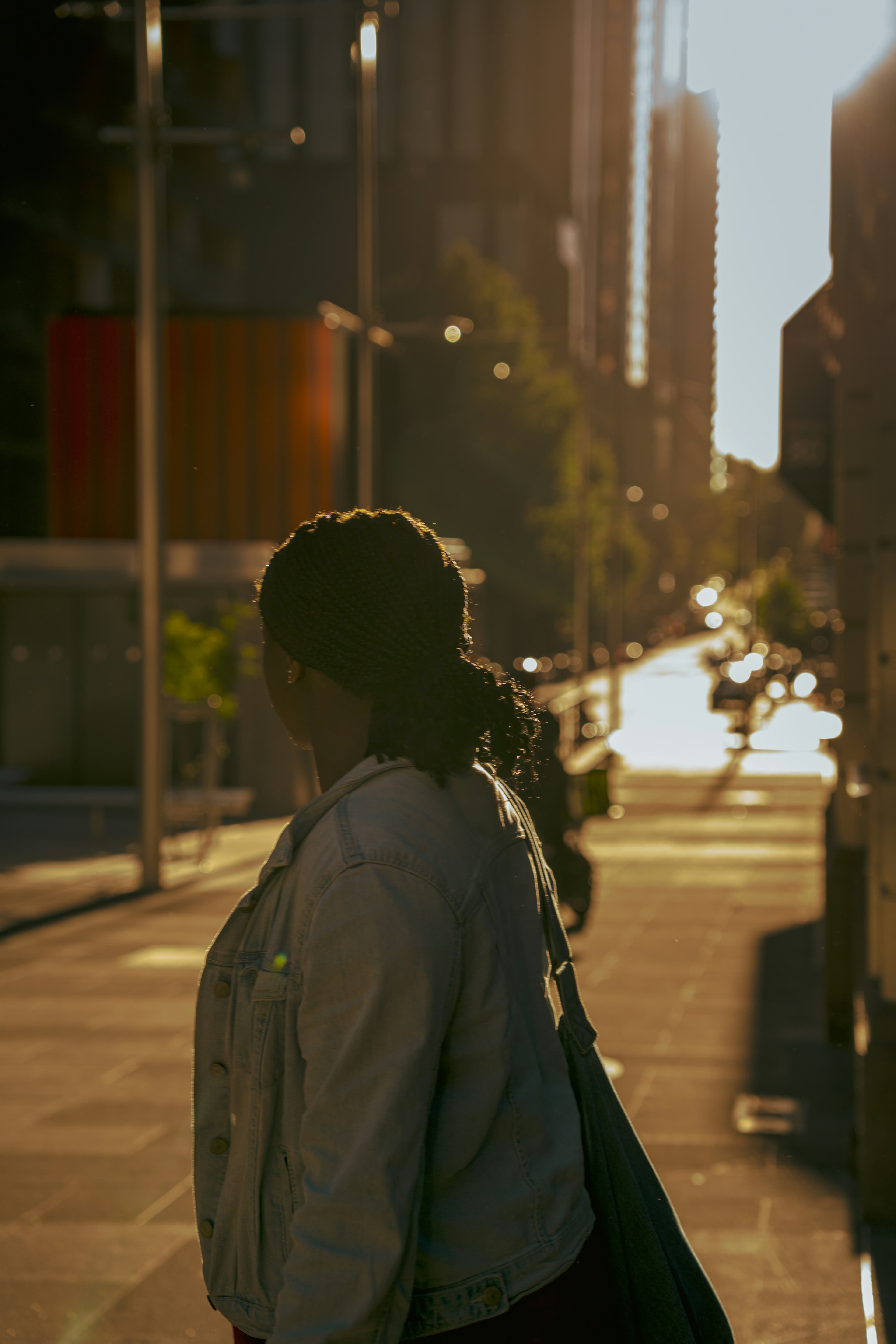 Silhouette of a person in a golden hour urban setting